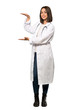 © luismolinero - A full-length shot of a Young doctor woman holding copyspace to insert an ad over isolated white background