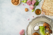 Jewish Holiday Passover Background With Matzo, Seder Plate And Spring Flowers.