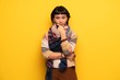 © luismolinero - Young hippie woman over yellow wall smiling and looking to the front with confident face