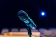© Andrey Lapshin - Wireless microphone on stand on blurred background. Empty audience.
