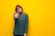 © luismolinero - Woman with glasses over yellow wall happy and counting four with fingers