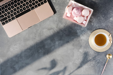 Wall Mural - Modern gray office desk table with laptop, other supplies with cup of tea. Top view, flat lay.