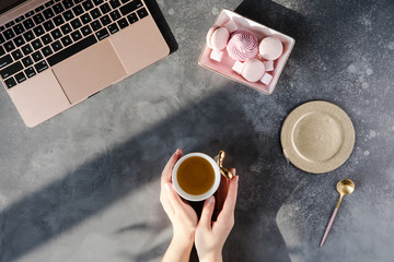 Wall Mural - Modern gray office desk table with laptop, other supplies with cup of tea. Top view, flat lay.