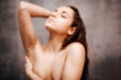 © estradaanton - Young attractive sexy woman in shower. Sexy hot chic posing with closed eyes. She cover breast with one hand. Blurred photo.