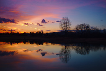 Wall Mural - Beautiful red and blue colors and reflection after sunset over a lake