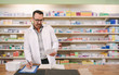 © Jacob Lund - Male pharmacist writing prescription at workplace