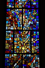 Abstract multicolor sun pattern of a stained glass window mosaic in a Toronto Roman Catholic church