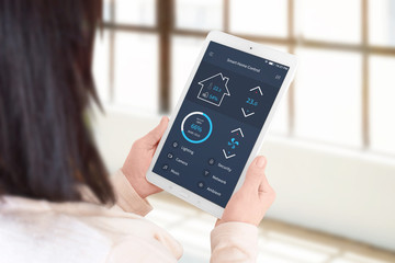 Poster - Woman use smart home control app to set the temperature and lighting. Living room, home management concept.