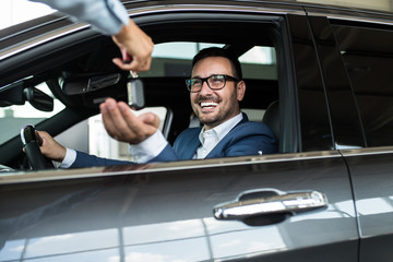 Wall Mural - Excited man happy because of buying a new car.