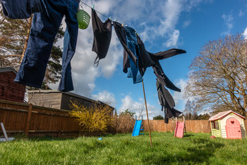 Wall Mural - Clothes drying outside on a washing line on a windy day