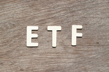 Wall Mural - Alphabet letter in word ETF (abbreviation of Exchange Traded Fund) on wood background