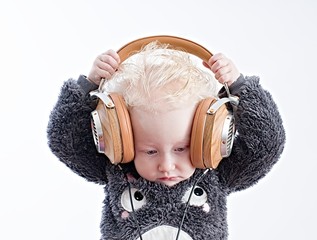 Wall Mural - Baby listening music in headphones