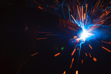 Arc Welding. Welding Of Two Metal Plates In Inert Gases. MIG / MAG. A Bright Flash Of Light And A Sheaf Of Sparks.