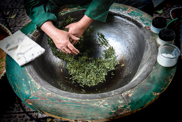 Traditional tea making Drying green tea in pan processing by hand at Longjing Village in Hangzhou China.