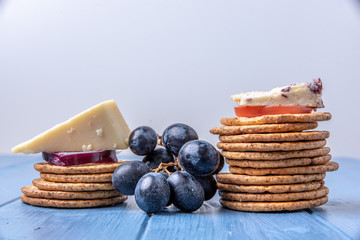 Crackers in a stack topped with cheese