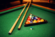 Billiard Balls, Cue And Pyramid On Green Table