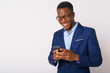 © Ranta Images - Portrait of young happy African businessman using phone