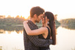 © satura_ - Relationship, love and nature concept - Close up portrait of attractive woman and handsome man hugging on the background of the lake