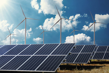 Wall Mural - clean energy power concept solar panel with wind turbine and blue sky background