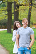 © Elena Kratovich - Happy couple expecting pregnancy portrait in park