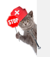 Poster - Cat  with a stethoscope on his neck holding sign stop in paw behind empty white banner. isolated on white background
