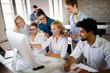 © NDABCREATIVITY - Successful happy group of people learning software engineering and business during presentation