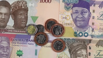 Wall Mural - Nigeria naira notes and coins rotating. Nigerian money, currency. 4K stock video footage