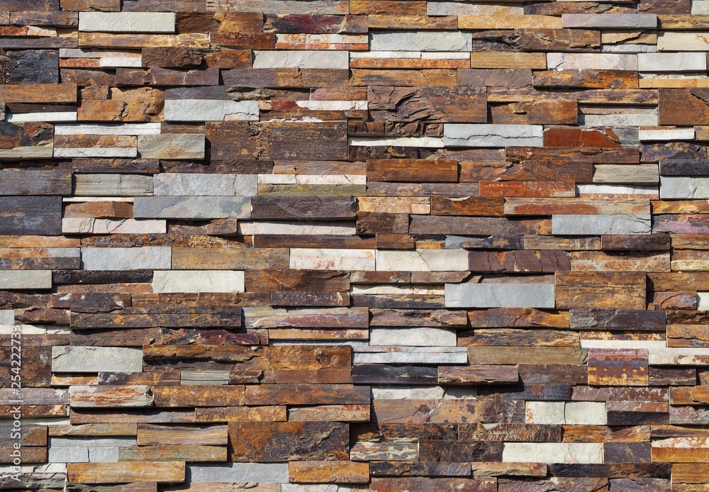 Stone cladding wall made of striped stacked slabs of natural colored ...