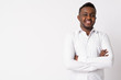 © Ranta Images - Portrait of happy young African businessman smiling with arms crossed