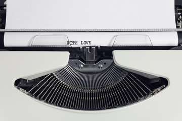 Fototapete - Old retro obsolete white typewriter with close-up typing text With Love as heading on paper