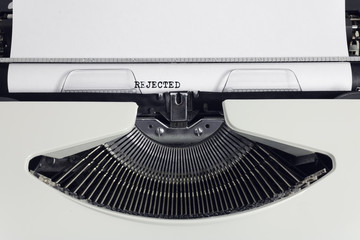Fototapete - Old retro obsolete white typewriter with close-up typing text rejected as heading on paper