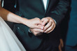 © Vardan - Bride and groom holding hands in church