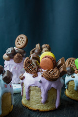 Wall Mural - Easter, Easter cakes are decorated with chocolate and macaroons. Traditional Kulich, Easter Bread. Spring holiday in memory of the resurrection of Christ. Dark background.