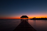 Fototapeta Na ścianę - beautiful sunrise, meditation in the lagoon of the seven colors, in Bacalar, Quintana Roo, Mexico.