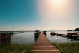 Fototapeta  - Sunset in the wooden harbor in summer,Bacalar,Quintana Roo, Mexico.
