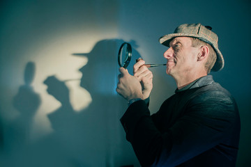 detective at work with magnifying glass and pipe investigating crimes