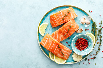 Seafood. Fresh raw salmon or trout fillets with ingredients, top view, space for a text