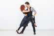 © satura_ - Social dance, bachata, kizomba, tango, salsa, people concept - Young couple dancing over white background