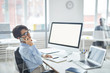 © Seventyfour - Busy young employee or agent consulting client on the phone while sitting by desk in office