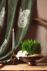 Wall Mural - Novruz still life with semeni sabzi wheat grass , silk national scarf, eastern musical instrument and orchids. Spring equinox in March celebration, copy space 