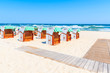 Wicker chairs on sandy beach in Baabe village, Ruegen island, Baltic Sea, Germany.