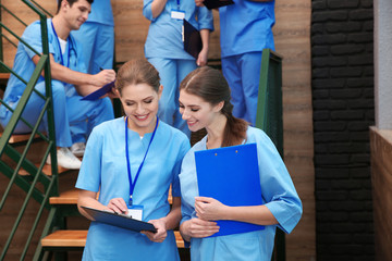 Canvas Print - Young smiling medical students in university hall