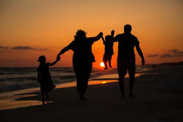 silhouette of family on the beach