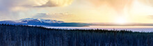 Panoramic Frozen Winter Landscape View Of Yellowstone National Park With Sunlight Shining In The Background Of The Snowy Mountain Range