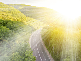 Wall Mural - bright summer sunshine in the high mountains covered with forest b