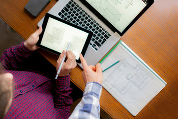 two men coworking with computer and constructing business plan b