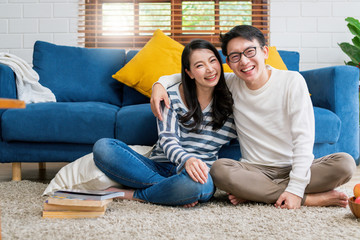 sweet lovey asian family couple sit talk good conversation on sofa in living room house background