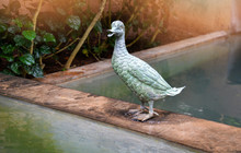 The Green Duck Statue Garden Standing On The Water Pond In The Park