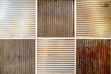 Pattern of wall made of old and new galvanized steel sheet in square-shaped connected together with rustic and modern look.