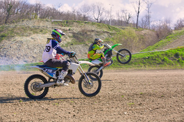 competition between two motocross bikes, side view